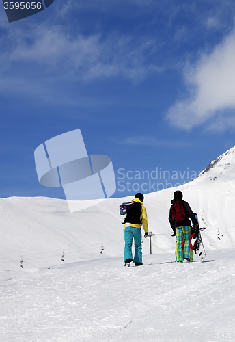 Image of Snowboarders on slope at sun nice day