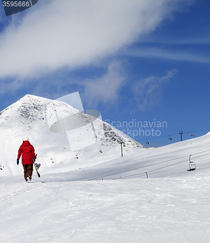 Image of Snowboarder on slope at sun nice day