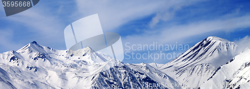 Image of Panoramic view on winter snowy mountains in windy day