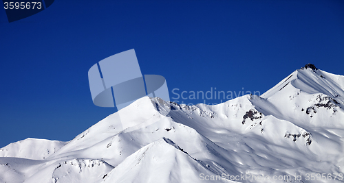 Image of Panoramic view on snowy winter mountains and clear blue sky in s