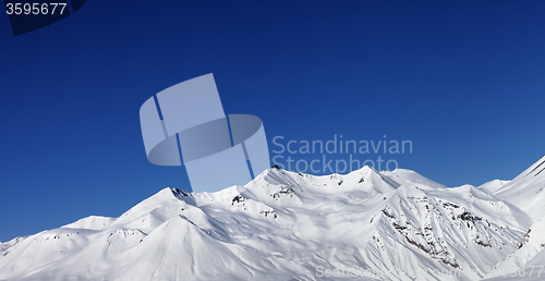 Image of Panoramic view on snowy mountains at sun day