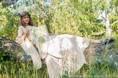 Image of Beatiful woman in national dress and flower wreath