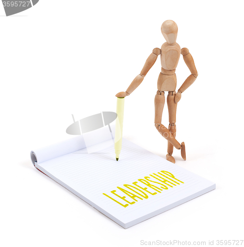 Image of Wooden mannequin writing - Leadership