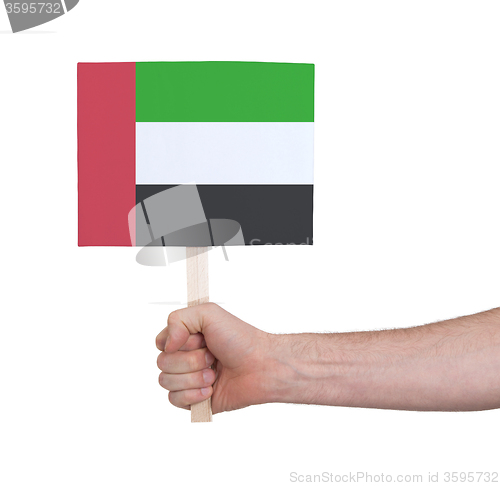 Image of Hand holding small card - Flag of Sudan