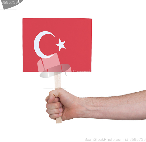 Image of Hand holding small card - Flag of Turkey