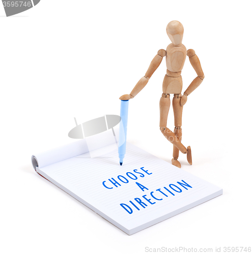 Image of Wooden mannequin writing - Choose a direction