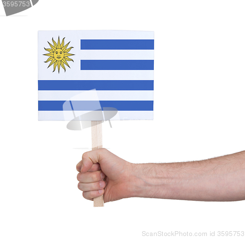 Image of Hand holding small card - Flag of Uruguay