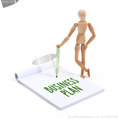 Image of Wooden mannequin writing - Business plan