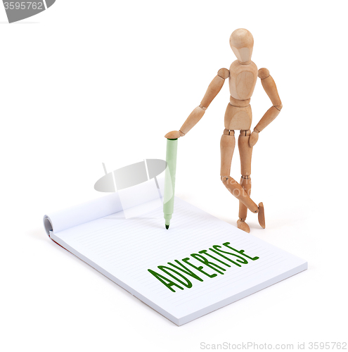 Image of Wooden mannequin writing - Advertise