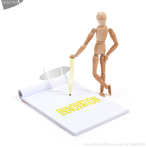 Image of Wooden mannequin writing - Innovation