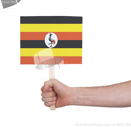 Image of Hand holding small card - Flag of Uganda