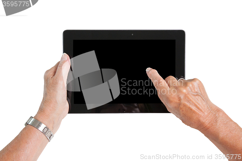 Image of Hands of senior lady relaxing and reading the screen of her tabl