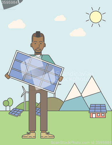 Image of Man with solar panels and wind turbines.
