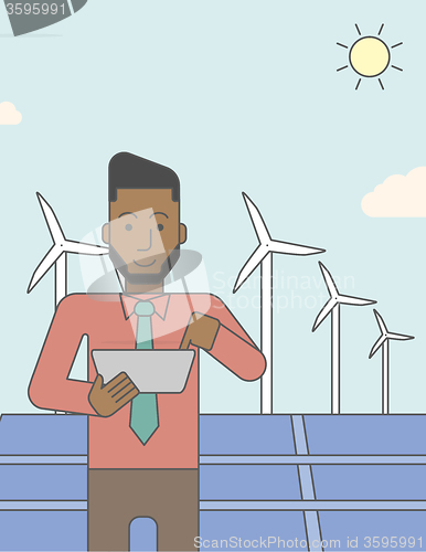 Image of Man with solar panels and wind turbines.