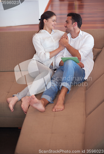 Image of couple at modern home using tablet computer