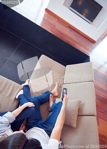 Image of young couple watching tv at home