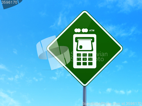 Image of Money concept: ATM Machine on road sign background