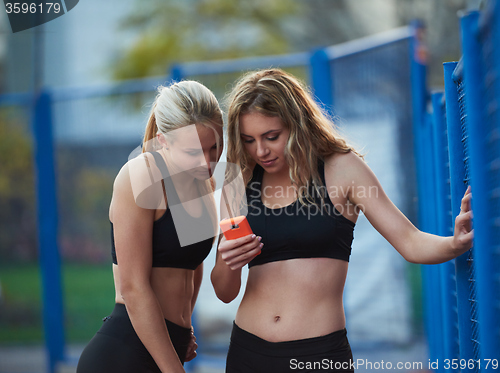 Image of friends on training using phone