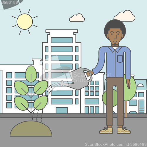 Image of Man watering tree.