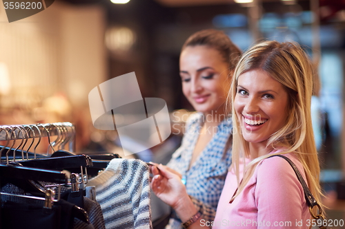 Image of happy young girls in  shopping mall