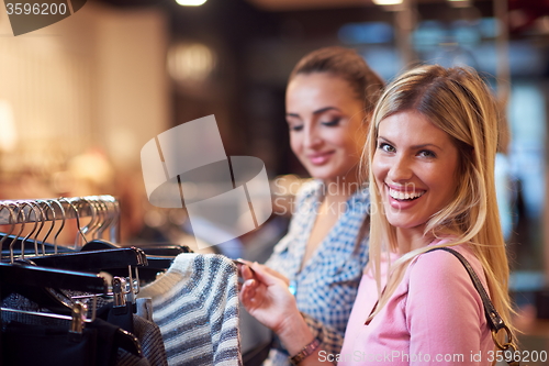 Image of happy young girls in  shopping mall