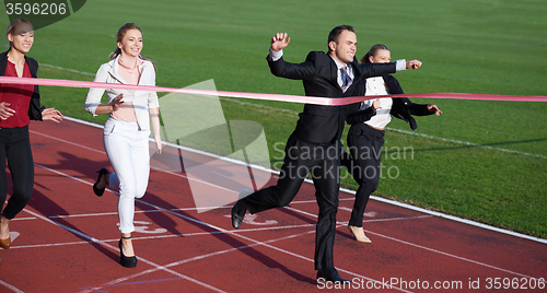 Image of business people running on racing track