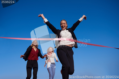 Image of business people running on racing track