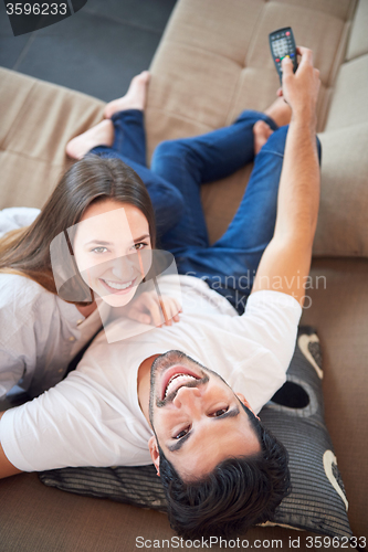 Image of young couple watching tv at home