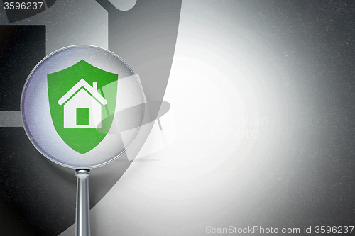 Image of Business concept:  Shield with optical glass on digital background
