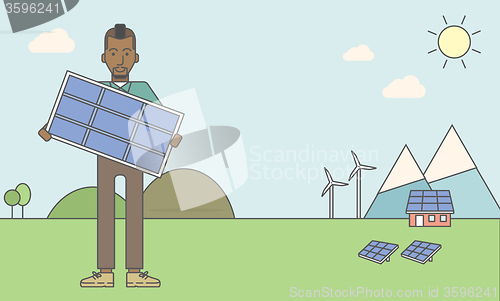 Image of Man with solar panels and wind turbines.