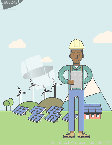 Image of Man with solar panels and wind turbines.