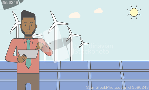 Image of Man with solar panels and wind turbines.