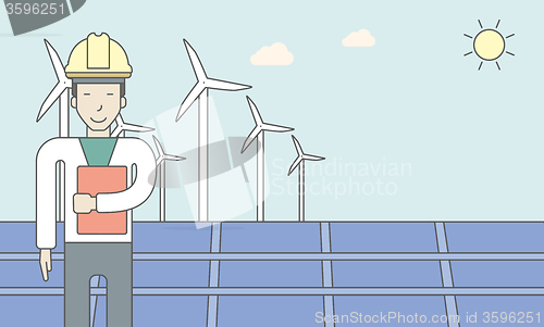 Image of Man with solar panels and wind turbines.
