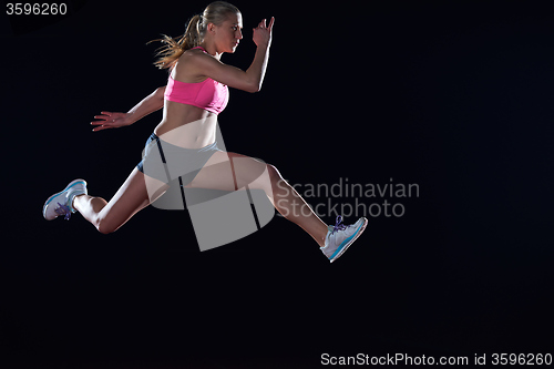 Image of Athletic woman running on track