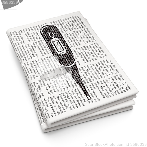 Image of Medicine concept: Thermometer on Newspaper background