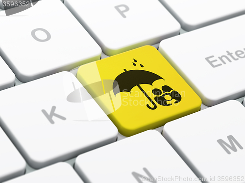 Image of Security concept: Family And Umbrella on computer keyboard background