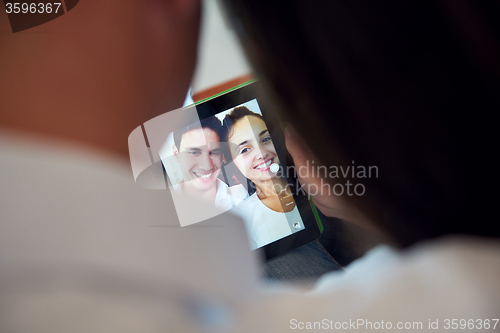 Image of couple at modern home using tablet computer