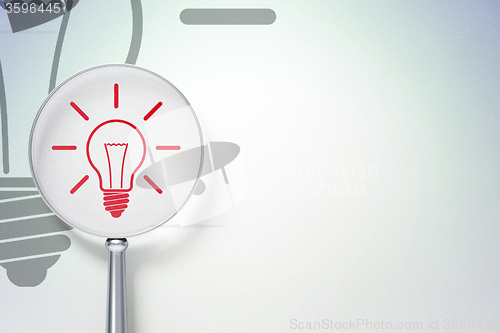 Image of Finance concept:  Light Bulb with optical glass on digital background