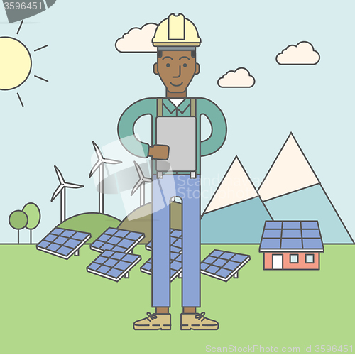 Image of Man with solar panels and wind turbines.