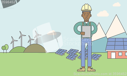 Image of Man with solar panels and wind turbines.