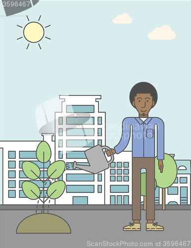 Image of Man watering tree.