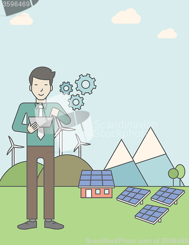 Image of Man with solar panels and wind turbines.