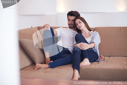 Image of young couple watching tv at home