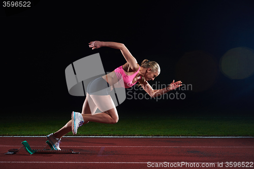 Image of pixelated design of woman  sprinter leaving starting blocks