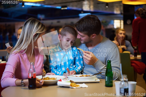 Image of family having lunch in shopping mall