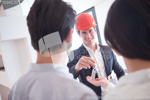 Image of couple buying new home with real estate agent