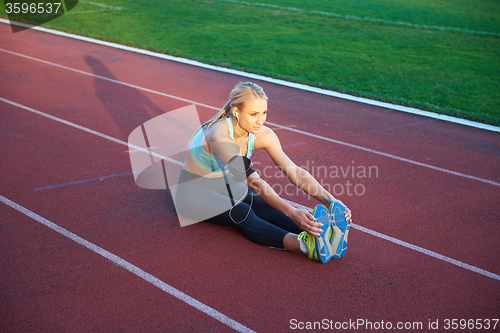 Image of sporty woman on athletic race track
