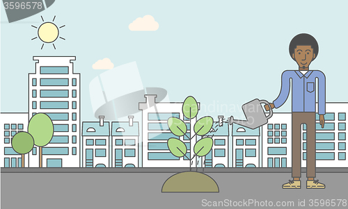 Image of Man watering tree.