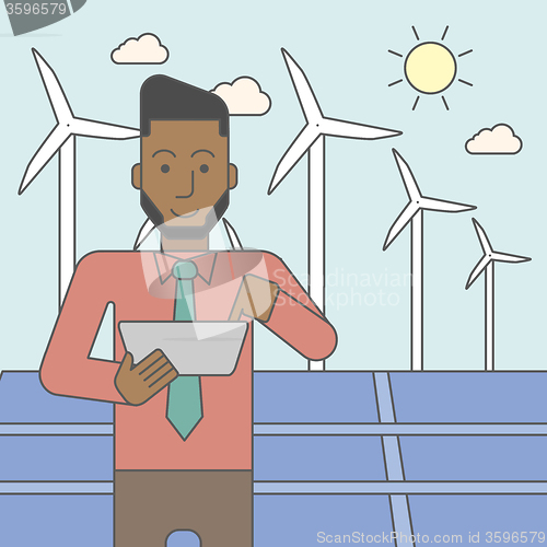 Image of Man with solar panels and wind turbines.