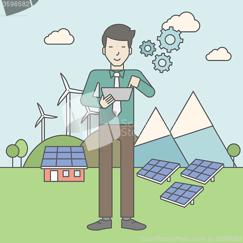 Image of Man with solar panels and wind turbines.